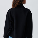 Back view of cropped dark navy jacket with high collar and loose sleeves