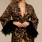 Leopard print kimono robe with V-neck, tied waist, and black faux feather cuff trim