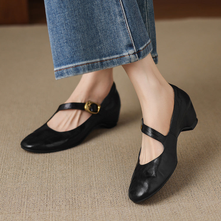 Black round-toe Mary Jane pumps with buckled strap and low block heel