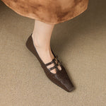 Brown Mary Jane flats with two buckle straps and perforated toe panel