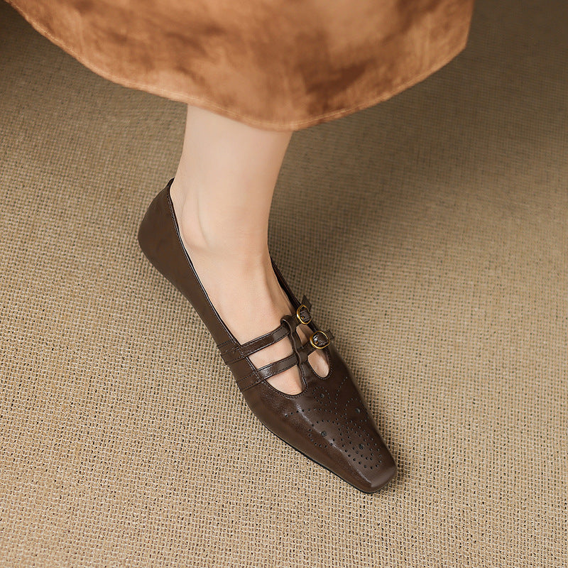 Brown Mary Jane flats with two buckle straps and perforated toe panel