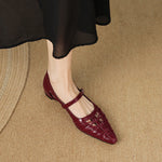 Burgundy Mary Jane flats with ankle strap and buckle, laced upper, pointed toe.
