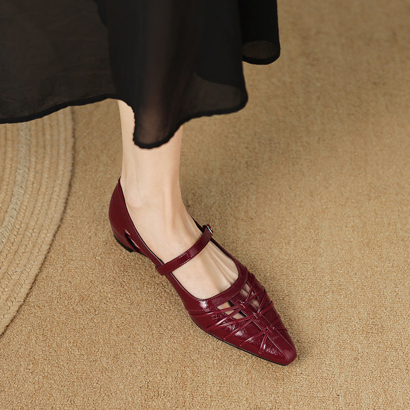 Burgundy Mary Jane flats with ankle strap and buckle, laced upper, pointed toe.