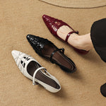 Mary Jane flats in cream, black, and burgundy with ankle straps and pointed toes