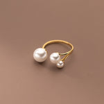 Gold triple-pearl adjustable ring with one large center pearl and two small pearls