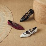 Mary Jane flats in burgundy and cream with ankle straps, plus black pair in background