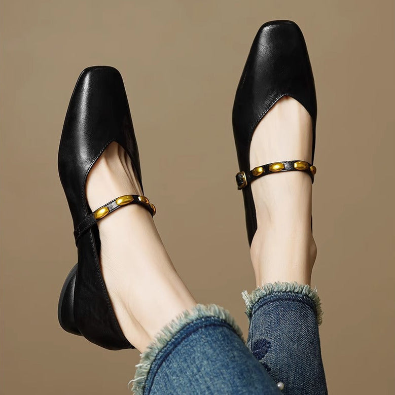 Black leather ballet flats with gold buckled strap and pointed toe