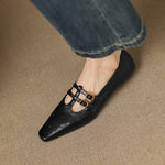 Ceyla black Mary Jane flats with perforations and two front straps with gold buckles