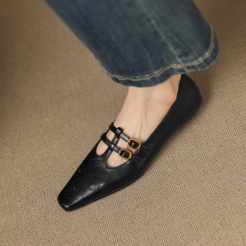 Ceyla black Mary Jane flats with perforations and two front straps with gold buckles