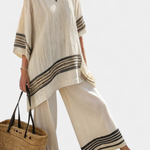 Women’s beige tunic top with black striped trim and wide-leg pants set