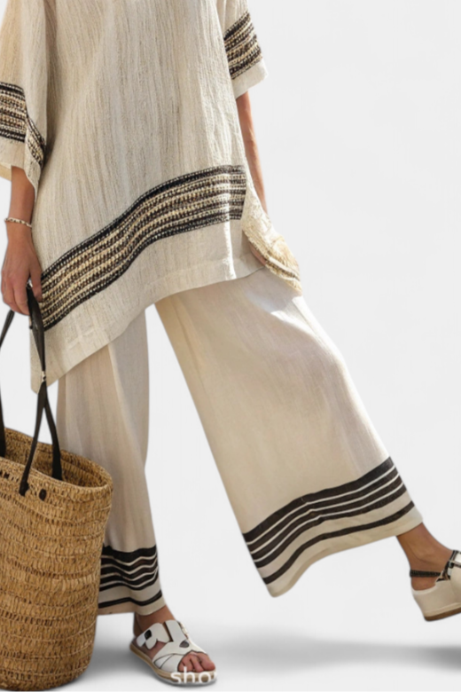 Beige tunic top and wide-leg pants with black striped cuffs and hem