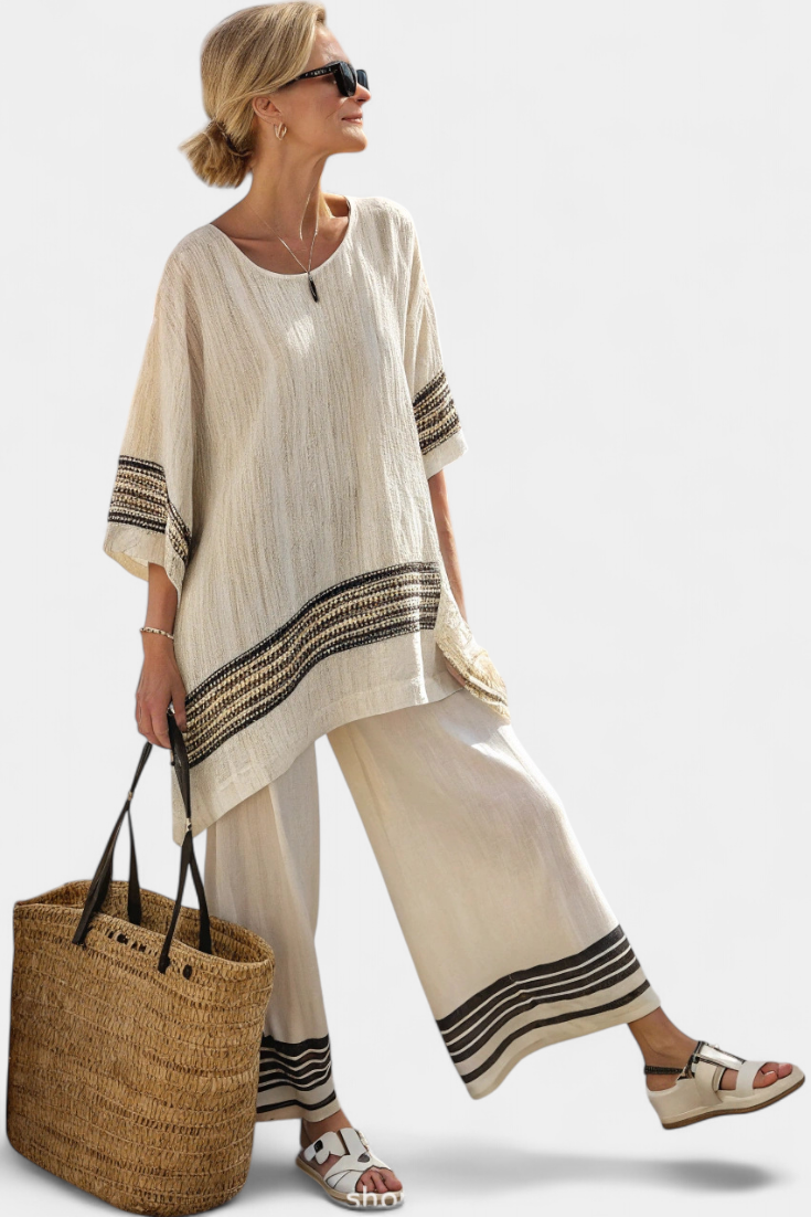 Women’s beige tunic top with round neck, black striped cuffs, and wide-leg pants