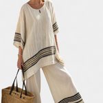 Women’s beige tunic top with round neck, black striped cuffs, and wide-leg pants
