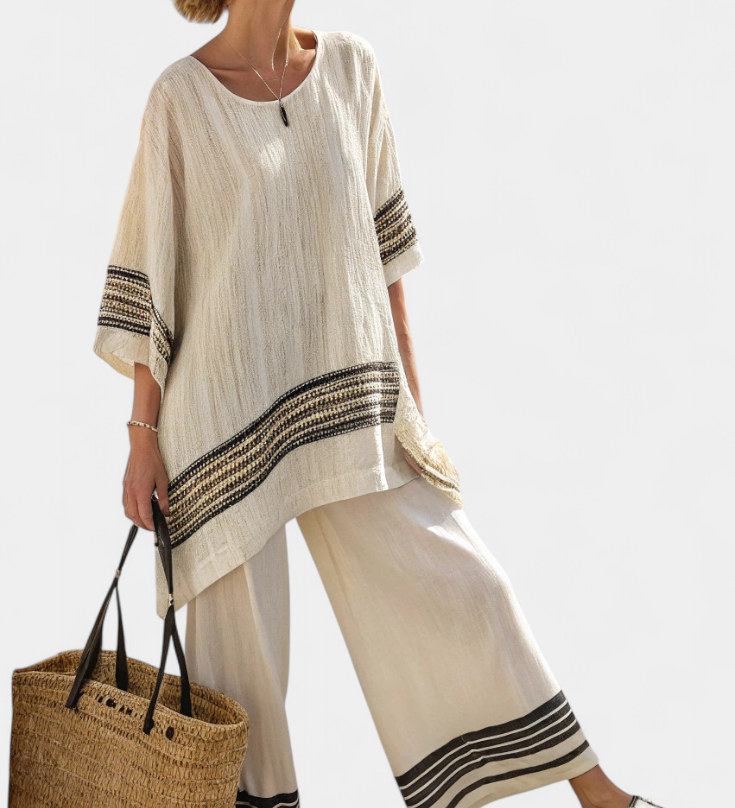 Women’s beige tunic top with round neck, black striped cuffs, and wide-leg pants