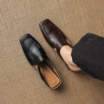 Black and dark brown leather mule loafers with peep cutout and block heels
