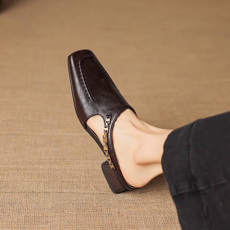 Dark brown leather mule loafers with open toe and patterned strap trim