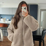 Beige sherpa zip-up winter jacket with stand collar and two front flap pockets