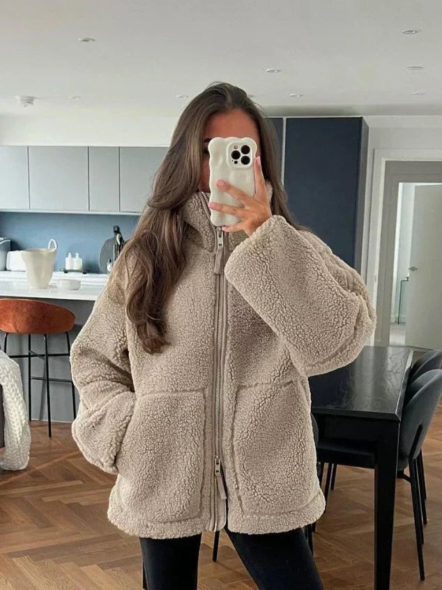 Beige sherpa zip-up winter jacket with stand collar and two front flap pockets