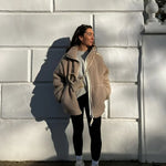 Tan sherpa zip-up winter jacket with stand collar and two front flap pockets