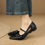 Black Mary Jane flats with ankle strap and lace-up lattice detail on the toe