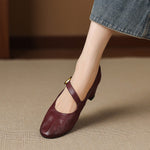 Burgundy round-toe Mary Jane pumps with buckled strap and low block heel