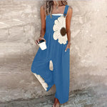 Loose printed overalls, sleeveless blue with large white daisy floral front, wide-leg fit