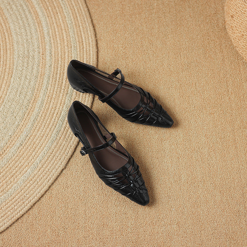 Black Mary Jane flats with ankle strap and crisscross detail; pair view
