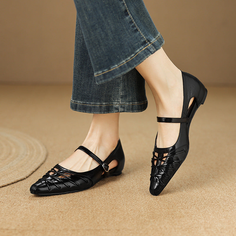 Black Mary Jane flats with ankle strap and pointed toe; worn with denim