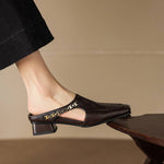 Dark brown leather mule loafers with decorative strap across the front