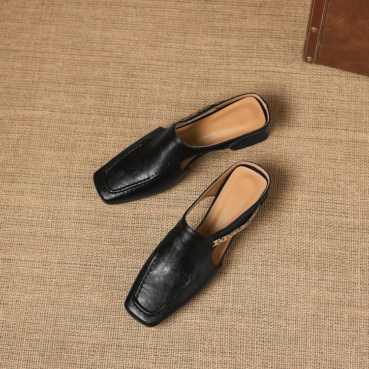 Two black leather mule flats with square toe, on beige fabric; one shows heel detail.