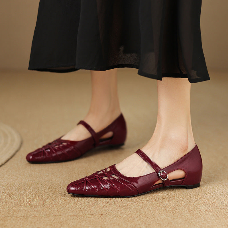 Burgundy Mary Jane flats with ankle strap and buckle, laced upper and low profile sole.