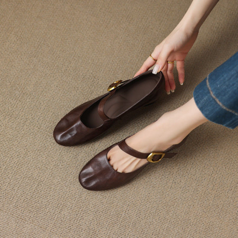 Dark brown Mary Jane flats with round toe and gold buckle strap