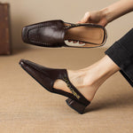 Dark brown leather mule loafers with side cutout and decorative strap detail