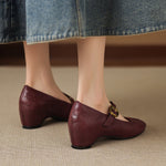 Burgundy Mary Jane pumps with buckled strap and low block heel, round toe