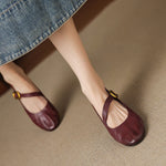 Burgundy Mary Jane pumps with buckled strap and round toe, low block heel