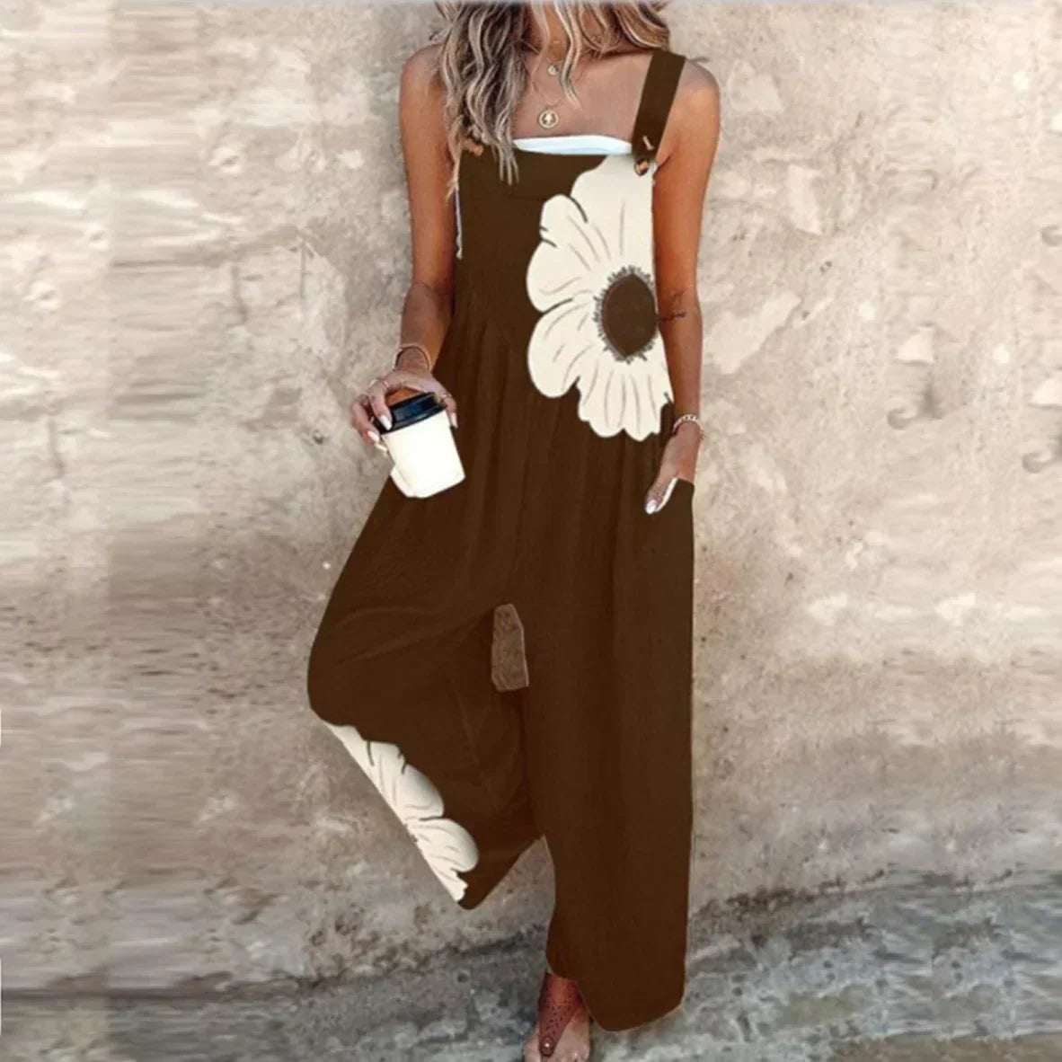 Loose printed overalls, sleeveless dark brown with large white daisy floral front, wide legs