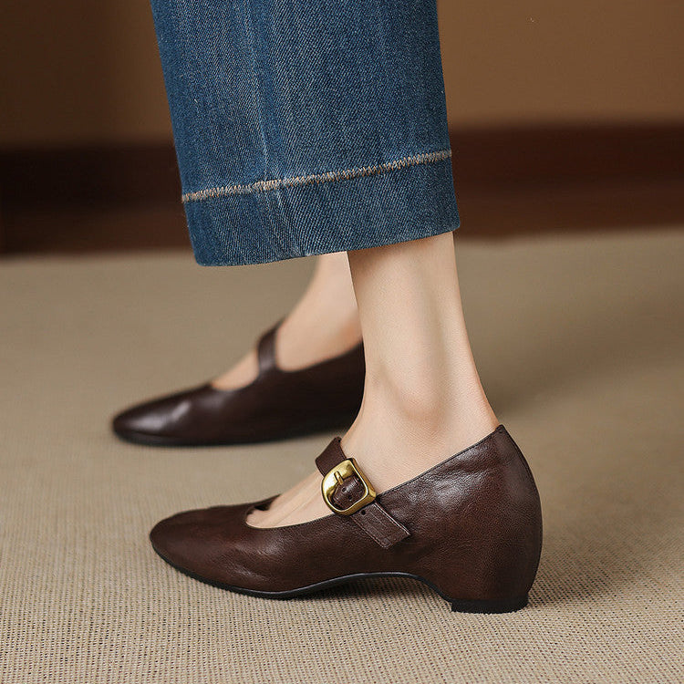 Dark brown Mary Jane shoes with round toe and buckle strap, side view