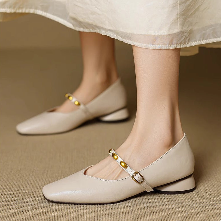 Beige leather ballet flats with gold buckle strap and stud trim