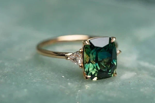 Vintage gold ring with square emerald-cut dark green gemstone and prong setting