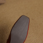 Red Mary Jane flat sole view, low profile with rounded square toe.