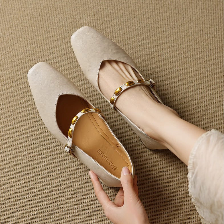 Light beige leather ballet flats with gold buckle strap and tan insole lining
