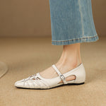 Cream Mary Jane flats with ankle strap and buckle, laced detailing, pointed toe.