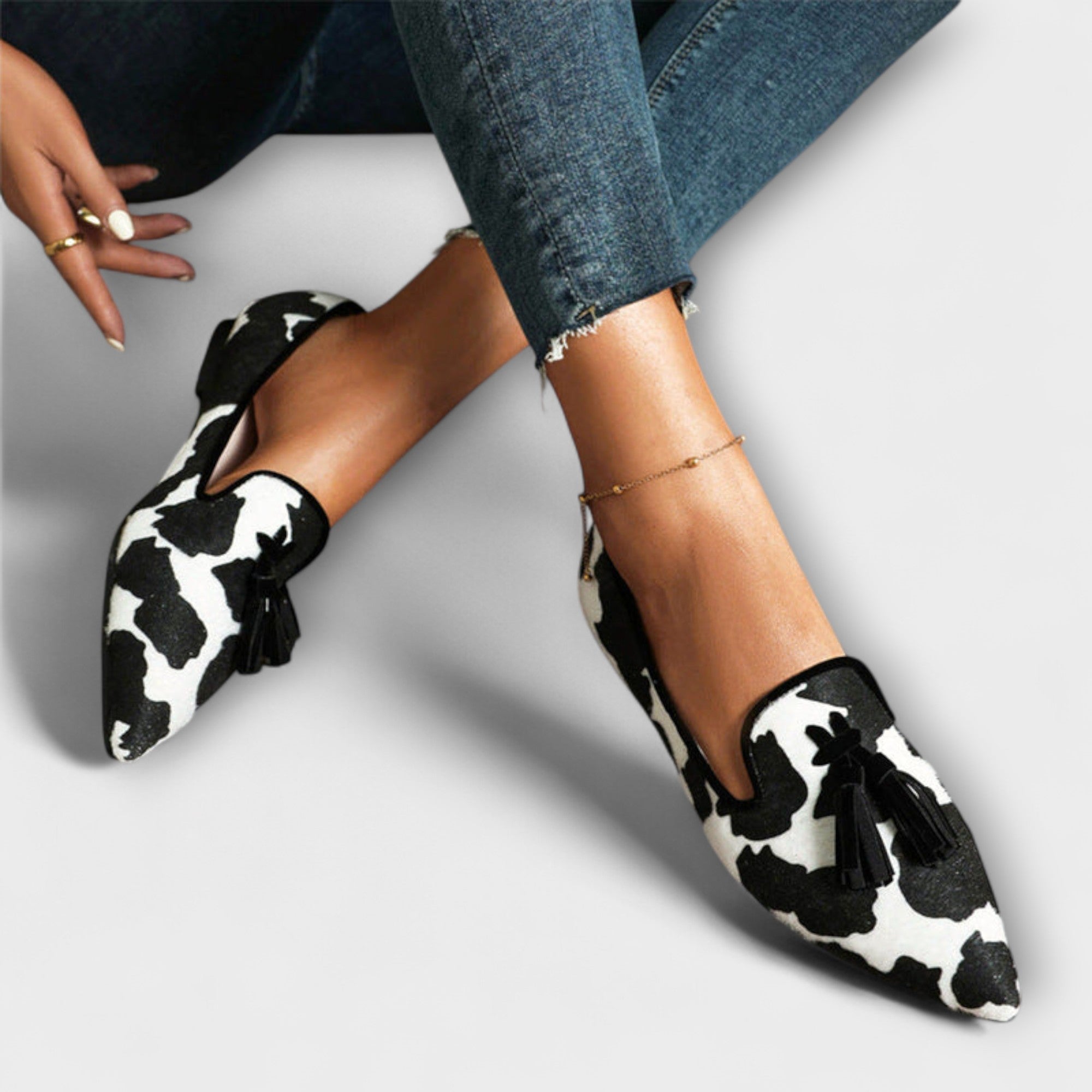 Julia cow-print loafers with black tassels and black-and-white uppers