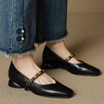 Black leather ballet flats with gold buckle strap and stud detail
