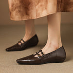 Brown Mary Jane flats with double buckle straps and perforated front