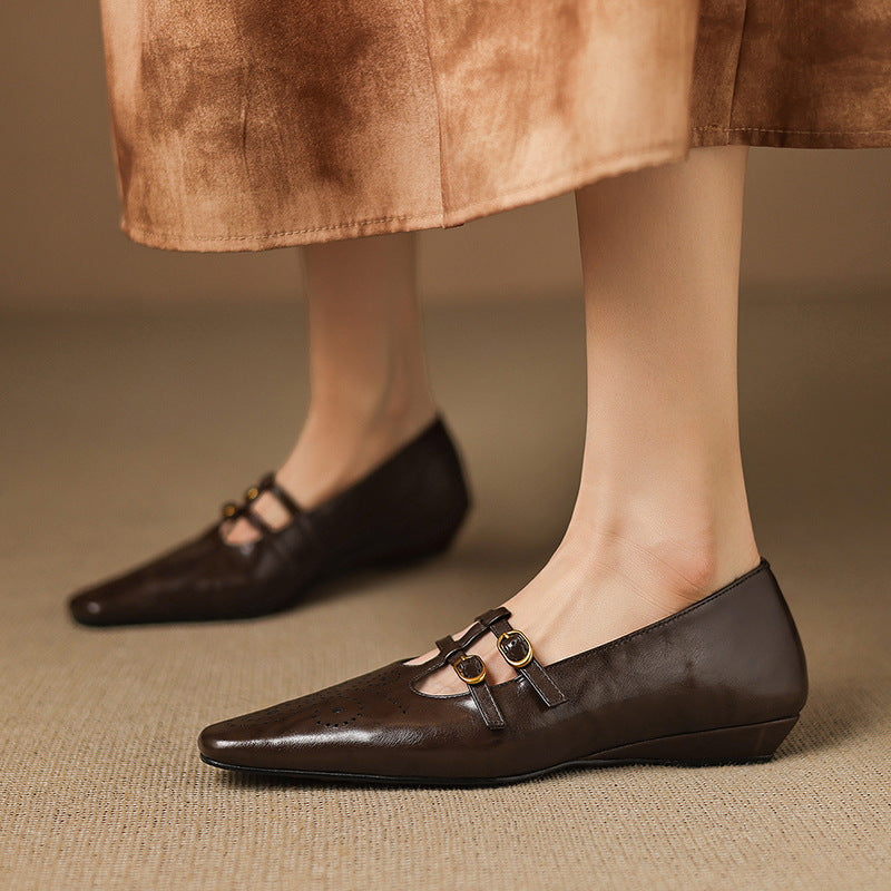 Brown Mary Jane flats with double buckle straps and perforated front