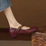 Burgundy round-toe Mary Jane pumps with buckled strap and low block heel
