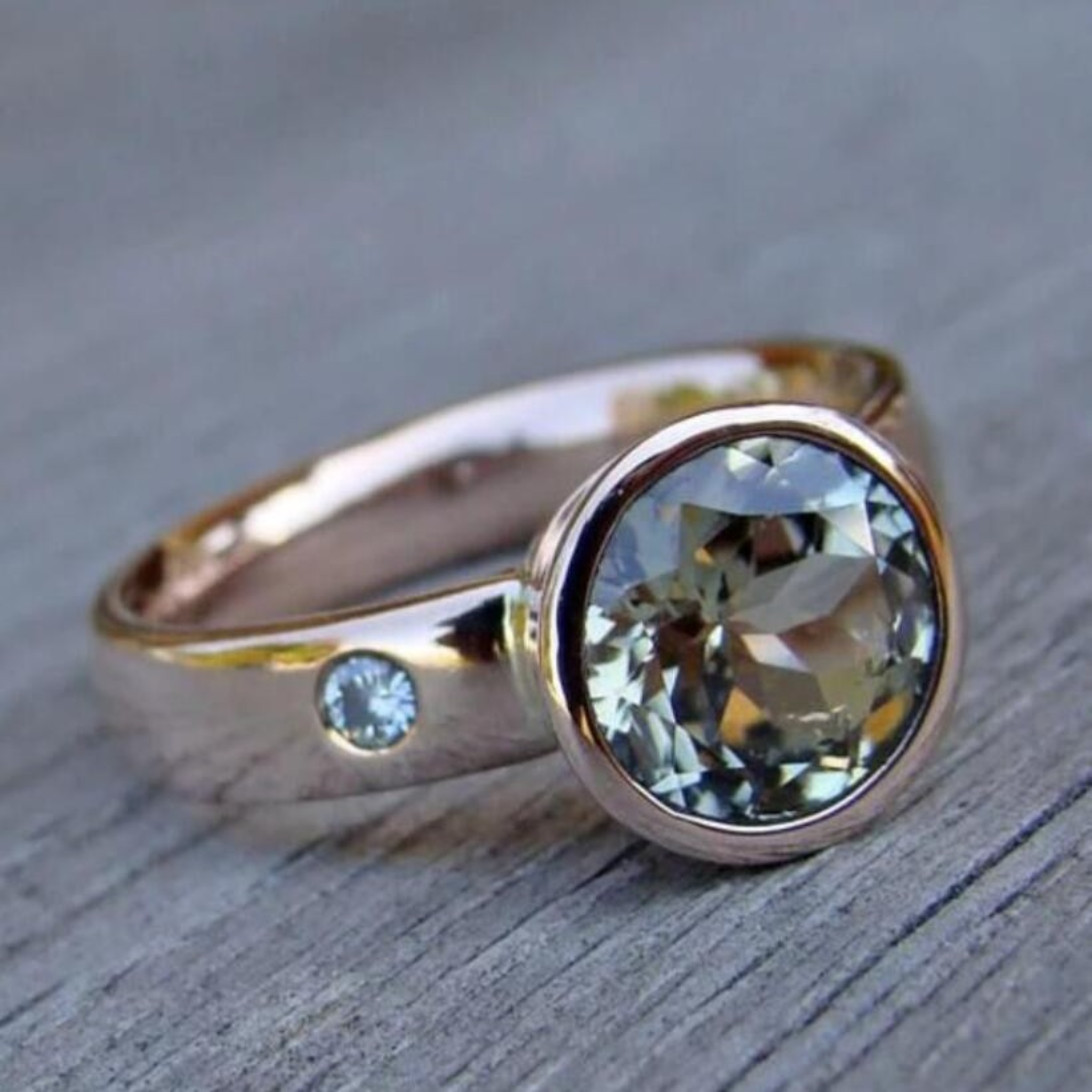 Vintage gold-tone ring with round clear zirconia center and small side stone
