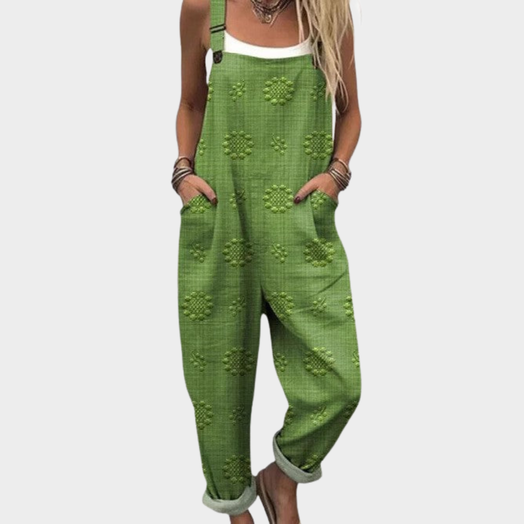 Loose green overalls with allover motif print, adjustable straps and ankle cuffs