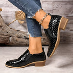 Black textured ankle boots with chain strap, rounded toe, and block heel